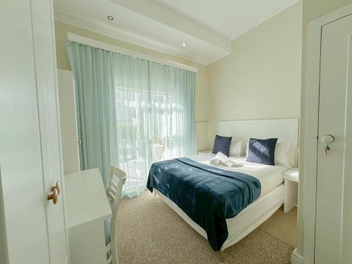 a bedroom with a bed and a window at Amoris In Sea Point in Cape Town