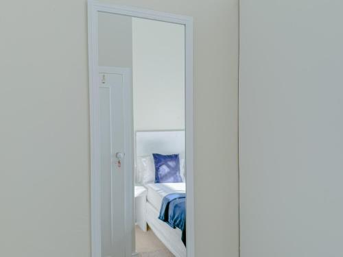 a bedroom with a door leading to a bed at Amoris In Sea Point in Cape Town