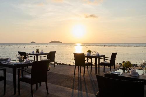 a restaurant with a view of the ocean at sunset at The Chill Resort and Spa, Koh Chang in Ko Chang