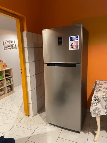 a stainless steel refrigerator in a kitchen at Location Chambres chez Zam in Bandrélé