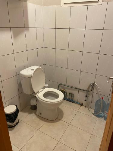 a bathroom with a toilet and a shower in it at Location Chambres chez Zam in Bandrélé