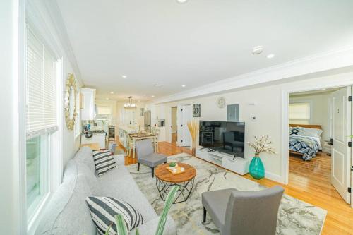 a living room with a couch and a table at 80-2 4BR Boston - Bright & Spacious Apt Family Stay near PJP II Park in Boston