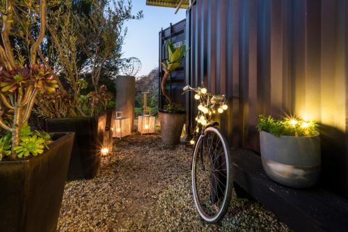 a bike parked next to a building with plants at Mia Mia House in Redesdale
