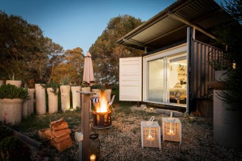 a backyard with a fire pit and an umbrella at Mia Mia House in Redesdale
