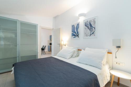 a bedroom with a bed and a table and a chair at Maca Apartments & Suites in Trogir