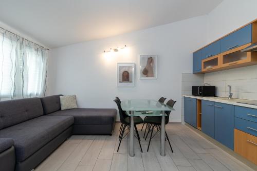 a living room with a couch and a table at Maca Apartments & Suites in Trogir