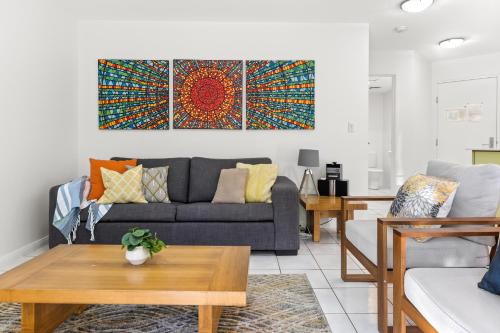 a living room with a couch and a table at Byron Getaway @ Eco Beach in Byron Bay