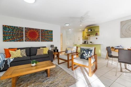 a living room with a couch and a table at Byron Getaway @ Eco Beach in Byron Bay
