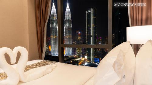 a hotel room with a view of the petronas towers at Imperial Luxury Suites KLCC by Moonway in Kuala Lumpur