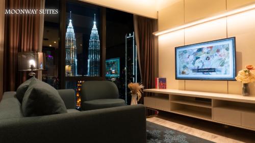 a living room with a tv and a couch at Imperial Luxury Suites KLCC by Moonway in Kuala Lumpur