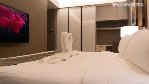 a bedroom with a bed with white socks on it at Imperial Luxury Suites KLCC by Moonway in Kuala Lumpur