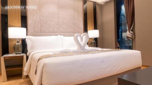 a bedroom with a bed with a swan on it at Imperial Luxury Suites KLCC by Moonway in Kuala Lumpur