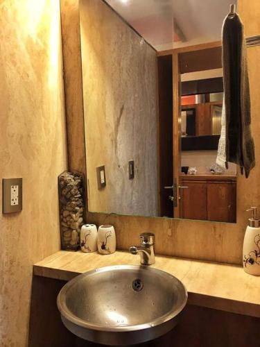 a bathroom with a sink and a mirror at Loft in Reforma 27 with Amazing balcony views on the 9th floor in Mexico City