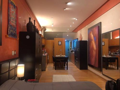 a living room with a kitchen and a dining room at Loft in Reforma 27 with Amazing balcony views on the 9th floor in Mexico City