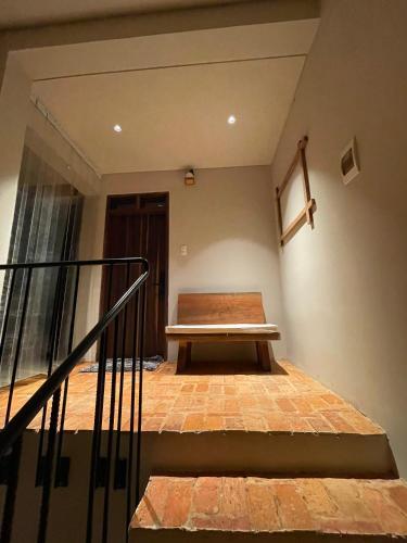 a wooden bench sitting on top of a staircase at Mành Farmhouse in Plei Brel (2)