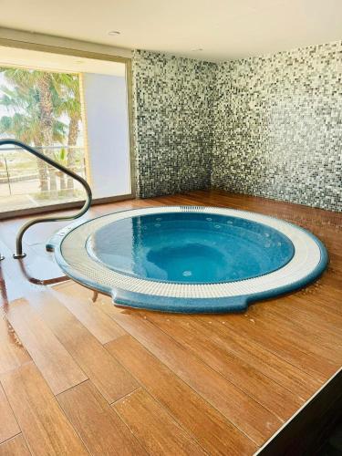 a large blue tub in a room with a wooden floor at Encanto del Mar La manga, Sea View in San Blas