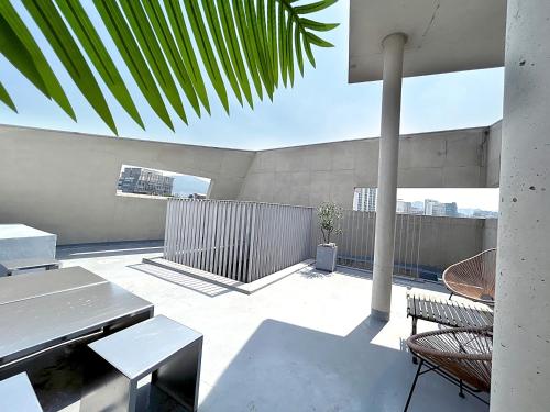 a patio with a table and chairs on a roof at Private duplex house with a nice rooftop - Foreigner only in Seoul