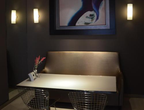 a bench with a table in a room with a painting at Jinjiang Inn Baoding Xiangyang Avenue in Baoding
