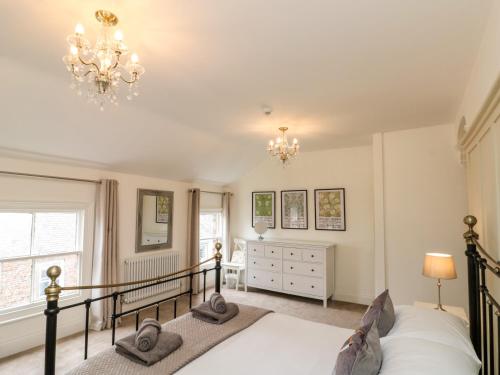 a bedroom with a bed and a chandelier at 10 Chaloner in Guisborough