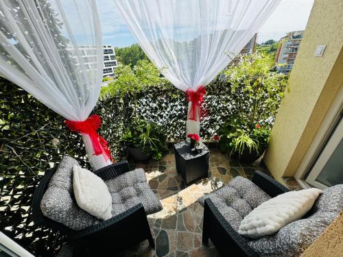 a balcony with two couches and a window at Aici te simți ca acasa in Iaşi