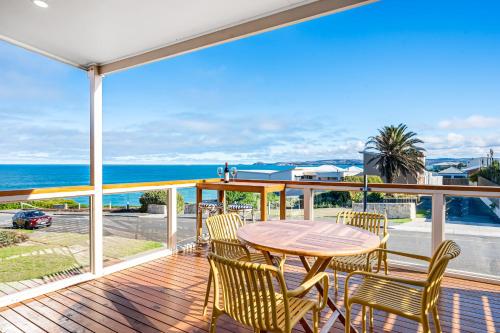a deck with a table and chairs and the ocean at bythesea - Oceanfront Living at Knights Beach in Port Elliot