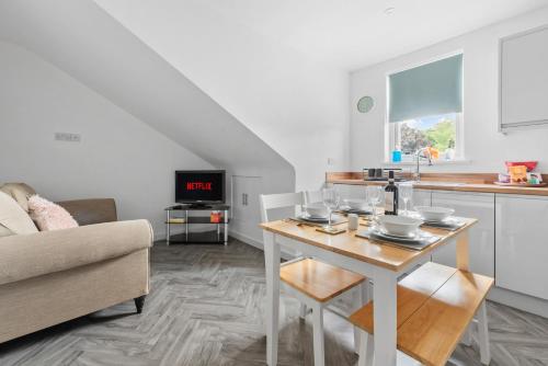 a living room with a table and a kitchen at Henwood Home Stays I 3 Modern Flats I Sleeps 4 in each in Worcester