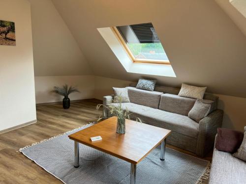 a living room with a couch and a table at Pension Spreewaldstube in Vetschau