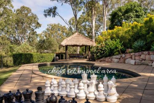 a chess set in a pool with a gazebo at Hideaway at Brookfield Acreage Tennis Court Pool in Brookfield