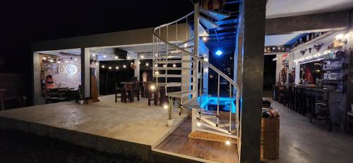a room with a staircase and a table and chairs at Seven 50s in Pai
