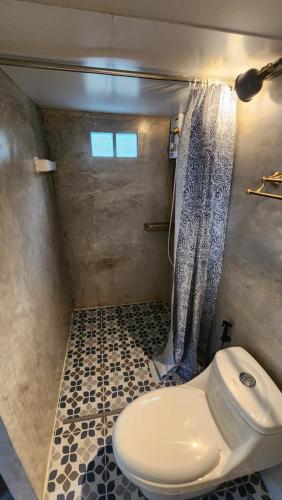 a bathroom with a toilet and a shower at Seven 50s in Pai