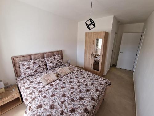 a bedroom with a bed with two pillows on it at Sky Apartment 3 in St Paul's Bay