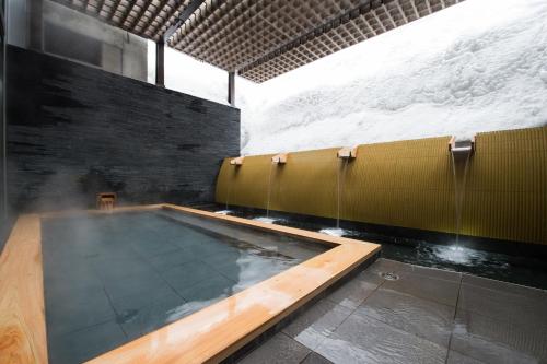 a swimming pool in a building with snow at Ki Niseko in Niseko