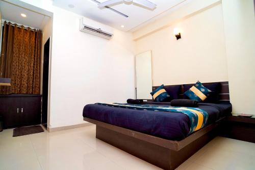 a bedroom with a large bed in a room at Hotel Shri Govind in Shirdi