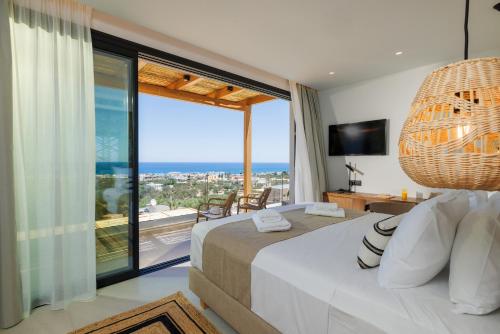 Кровать или кровати в номере Deos Luxury Suites - Adults Only