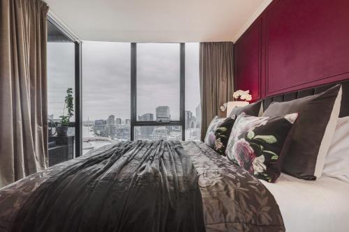 a bedroom with a large bed with a large window at VAQUAY Ambrosia In Southbank in Melbourne