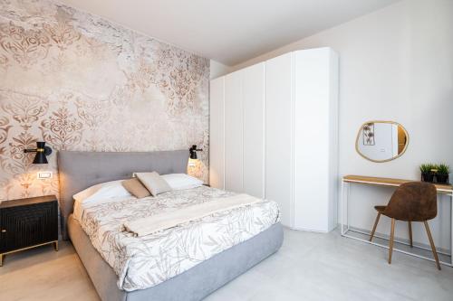 a bedroom with a bed and a mirror and a chair at Osmann Space in La Spezia
