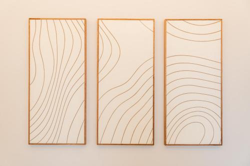 two stained glass windows with lines on a wall at Osmann Space in La Spezia