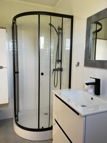 a bathroom with a shower and a sink at DomkiToTu in Jarosławiec