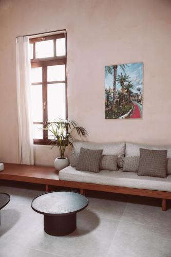 a living room with a couch and a table at MAZI - Pied à Terre in Rethymno