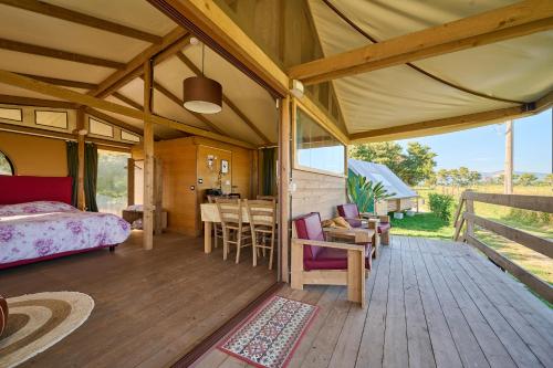 a room with a bed and a table and chairs at Suite Glamping vicino al mare in Piombino