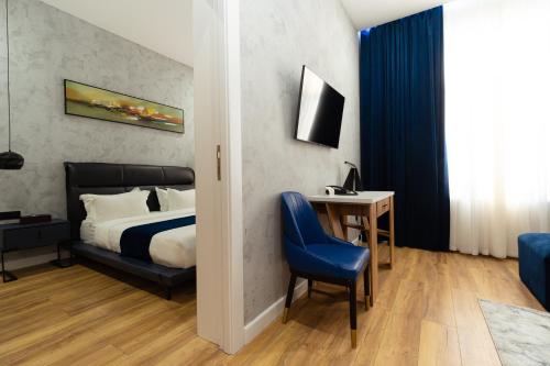 a bedroom with a bed and a desk and a chair at Harmony Luxury Hotel Tashkent in Tashkent