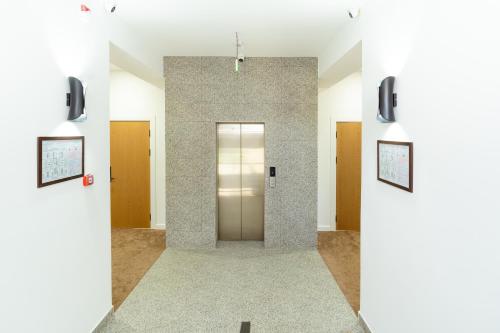 a hallway with a door in a building at Harmony Luxury Hotel Tashkent in Tashkent