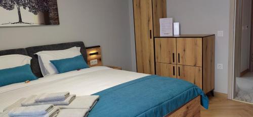 a bedroom with a large bed with towels on it at Apartmenthaus Oborishte - 31 in Panagyurishte