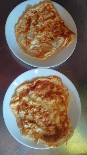 two white plates of food on a table at Argo Apartments in Kato Daratso