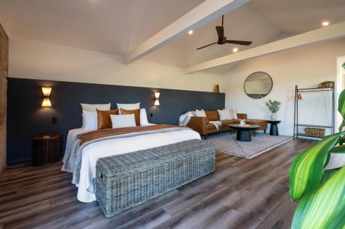 a bedroom with a large bed and a couch at Pokolbin Farm Stay in Pokolbin