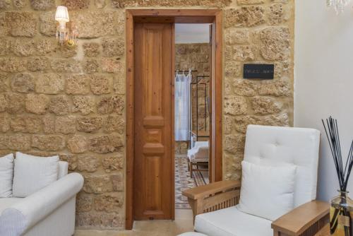 a living room with a couch and two chairs at Lebanese Diaspora Village in Batroûn