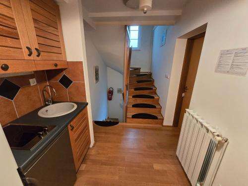 a bathroom with a sink and a staircase in a room at Villa Katarina in Krapinske Toplice
