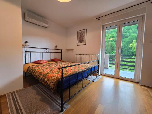 a bedroom with a bed and a large window at Villa Katarina in Krapinske Toplice