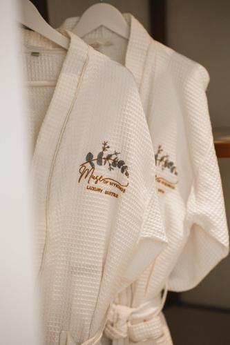 a white sweater with a group of animals on it at Muse οf Mykonos Luxury Suites in Mýkonos City