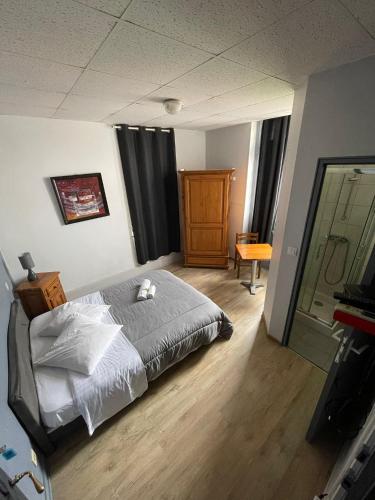 a bedroom with a bed with a teddy bear on it at bdm in Montastruc-la-Conseillère